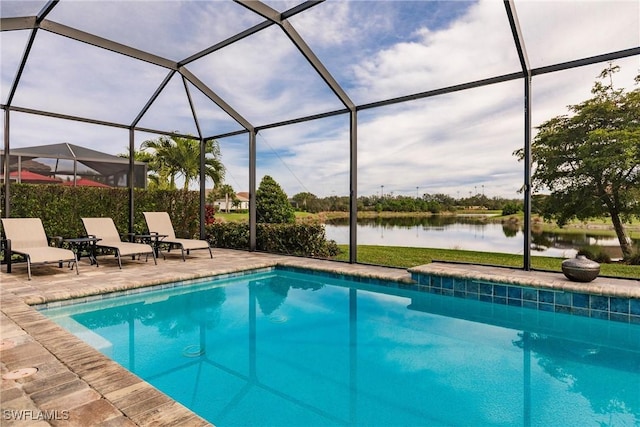 view of swimming pool with a lanai, a patio area, and a water view