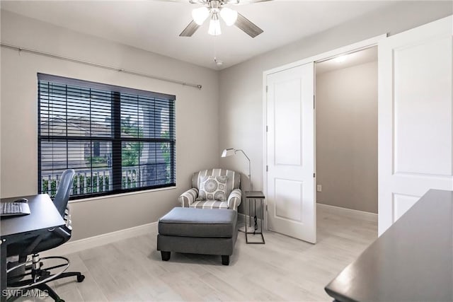 home office featuring light hardwood / wood-style flooring and ceiling fan