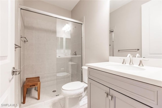 bathroom featuring tile patterned floors, vanity, walk in shower, and toilet