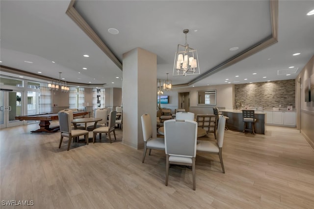 dining space featuring a raised ceiling, french doors, light hardwood / wood-style floors, and pool table