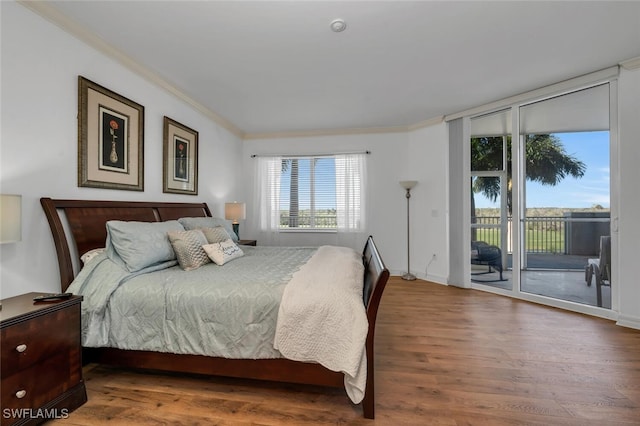 bedroom with access to outside, wood-type flooring, and ornamental molding