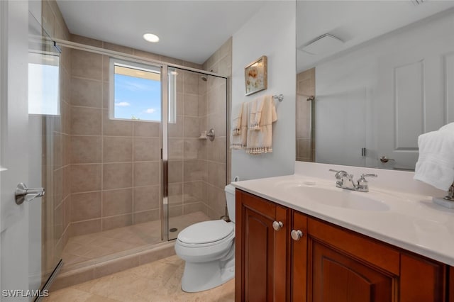 bathroom with tile patterned flooring, vanity, toilet, and an enclosed shower