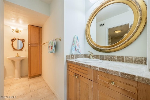 full bathroom featuring tile patterned flooring, visible vents, a sink, and baseboards