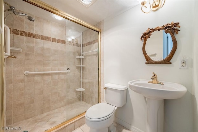 bathroom with a sink, a shower stall, and toilet