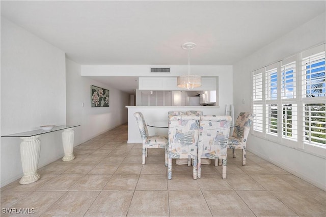 dining space featuring visible vents and light tile patterned flooring