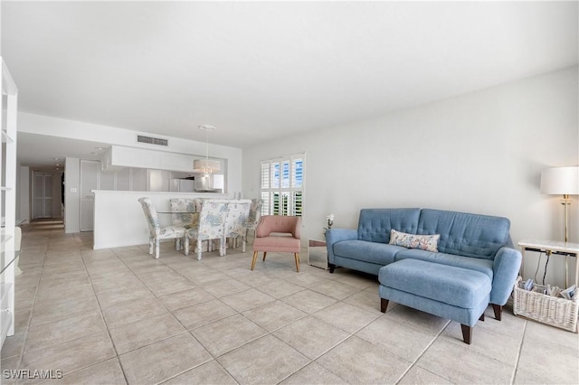 living room featuring light tile patterned floors and visible vents