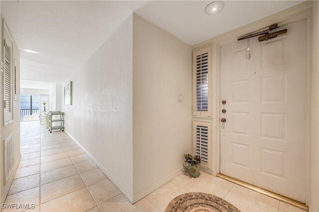 entrance foyer with light tile patterned flooring, visible vents, and baseboards