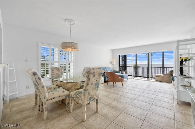 dining area featuring baseboards and light tile patterned floors