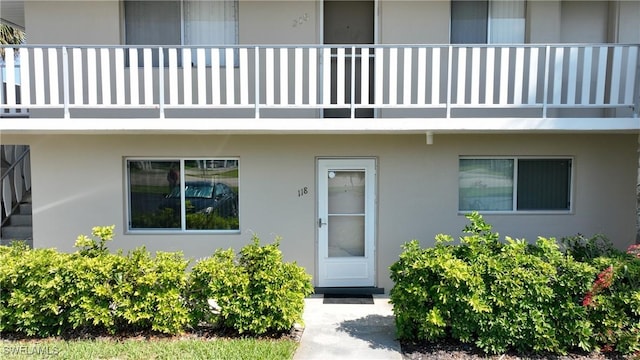 view of exterior entry with a balcony