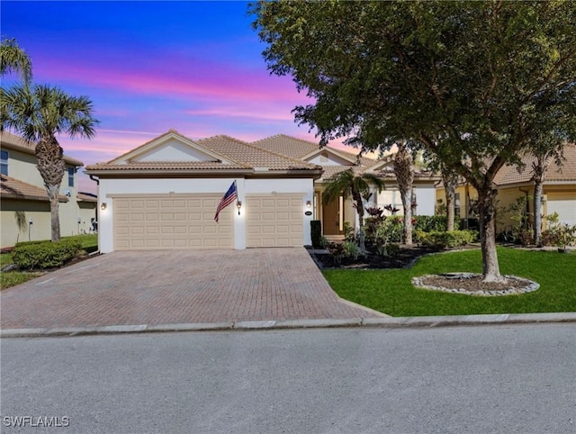 view of front of property featuring a yard and a garage