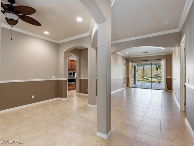 tiled empty room with ceiling fan and crown molding