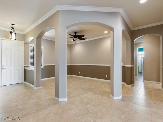 entrance foyer featuring ceiling fan and ornamental molding