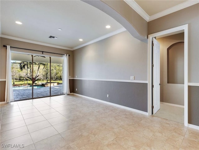 spare room featuring light tile patterned floors and ornamental molding