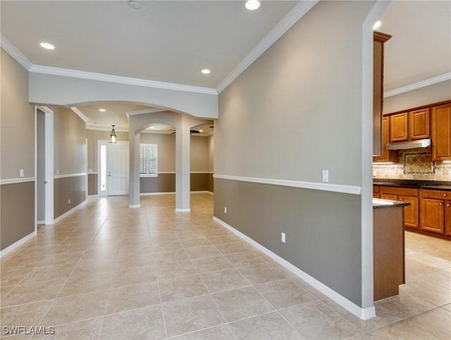 empty room featuring light tile patterned floors and ornamental molding