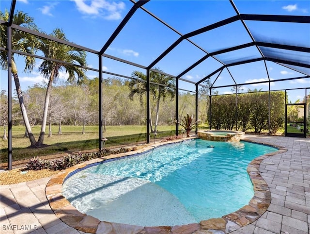 view of pool with a patio, glass enclosure, and an in ground hot tub