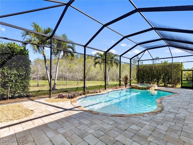 view of pool with a patio area, glass enclosure, and an in ground hot tub