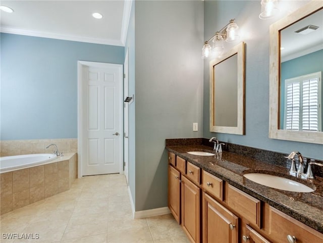 bathroom featuring vanity, tile patterned floors, ornamental molding, and tiled tub