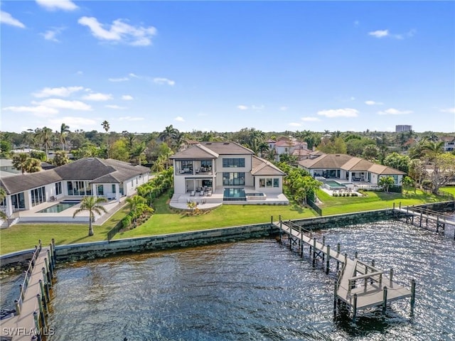 exterior space with a water view, a swimming pool, a balcony, a yard, and a patio area