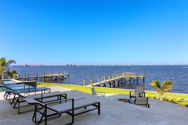 view of property's community with a boat dock, a water view, and a patio