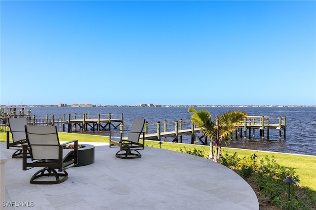 view of patio with a dock and a water view