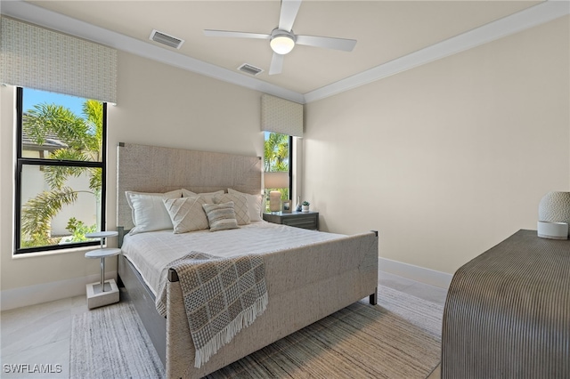 bedroom featuring ceiling fan and ornamental molding