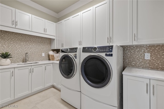 washroom featuring cabinets, light tile patterned floors, separate washer and dryer, and sink