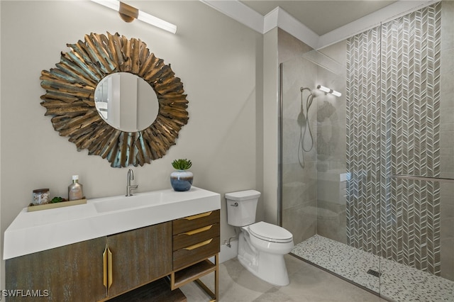 bathroom featuring a tile shower, vanity, and toilet