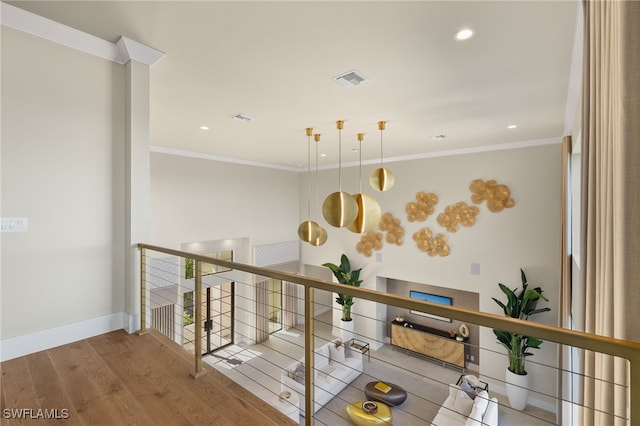 hallway with hardwood / wood-style flooring and ornamental molding