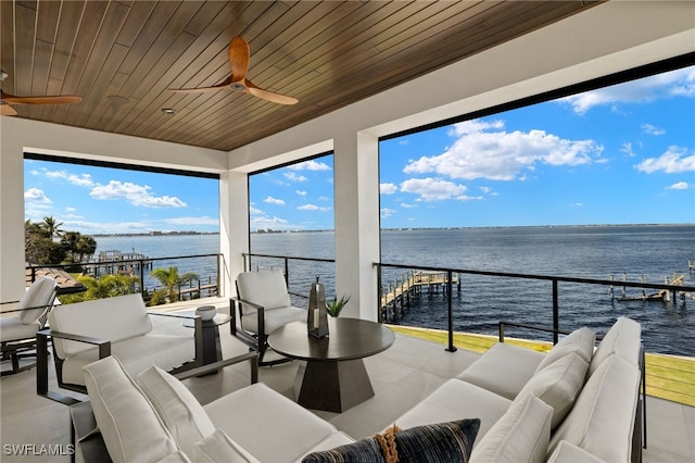 interior space featuring ceiling fan, a water view, and an outdoor hangout area