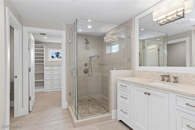 bathroom with vanity and an enclosed shower