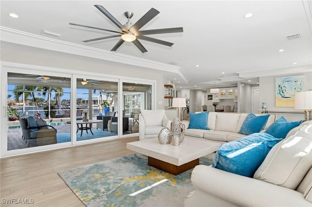 living room featuring crown molding, ceiling fan, and light hardwood / wood-style floors