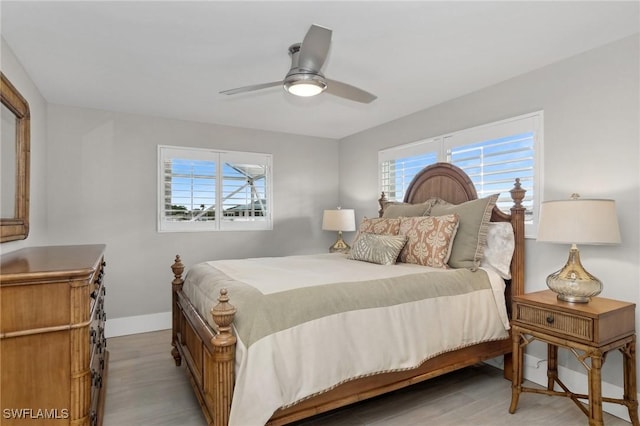 bedroom with light hardwood / wood-style flooring and ceiling fan