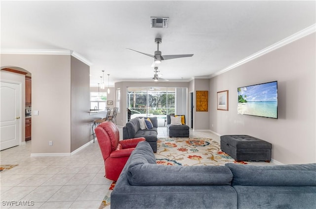 living room with ceiling fan, light tile patterned floors, and crown molding