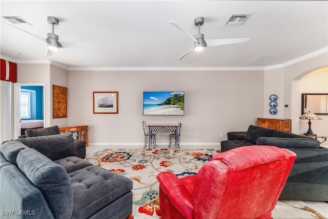 living room with ceiling fan and ornamental molding