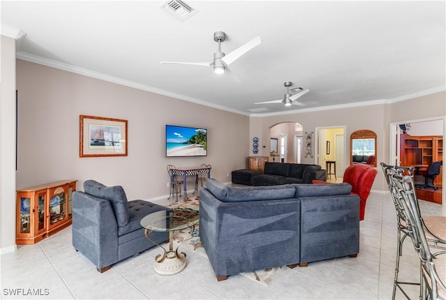 living room featuring ceiling fan, light tile patterned floors, and crown molding