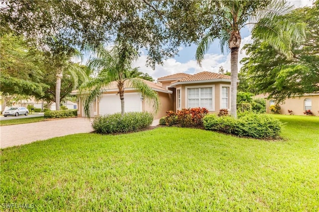 view of front of house featuring a front yard and a garage