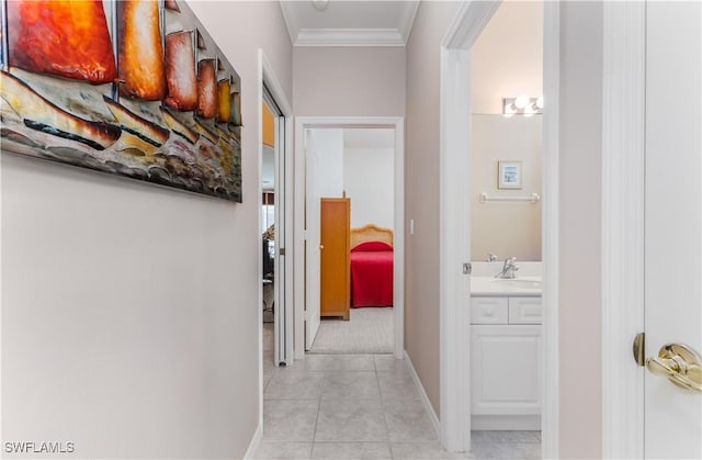 corridor featuring crown molding, sink, and light tile patterned flooring