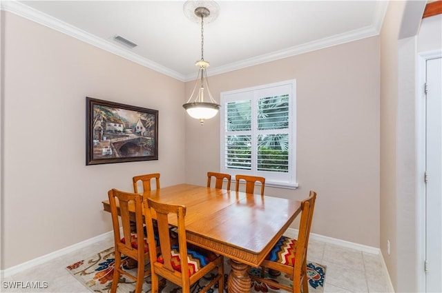 dining space with ornamental molding