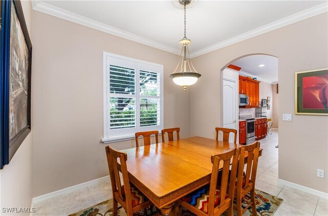 dining area with light tile patterned floors and crown molding