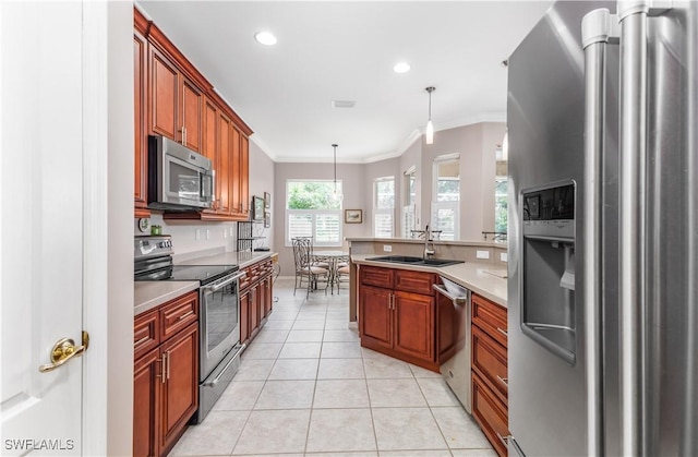 kitchen with sink, hanging light fixtures, appliances with stainless steel finishes, light tile patterned floors, and ornamental molding