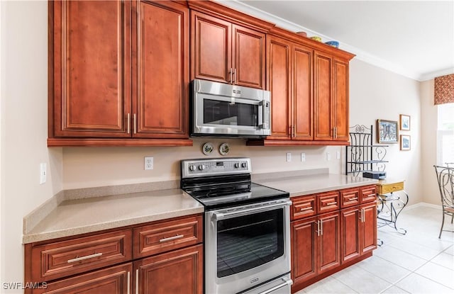 kitchen featuring crown molding, light tile patterned floors, and stainless steel appliances