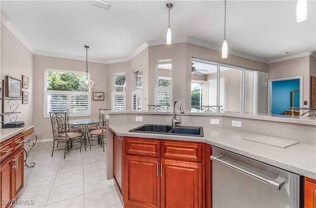 kitchen featuring stainless steel dishwasher, light tile patterned flooring, sink, and hanging light fixtures