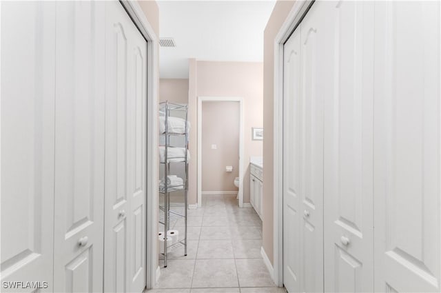 bathroom with tile patterned flooring, vanity, and toilet