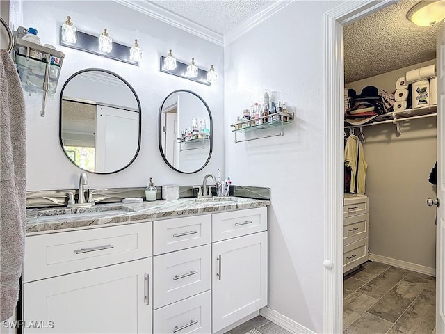 bathroom featuring vanity, a textured ceiling, and ornamental molding