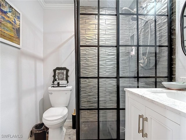 bathroom with a shower, crown molding, vanity, and toilet