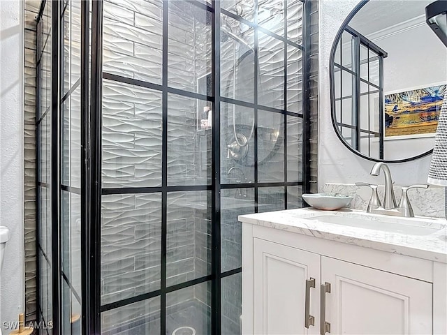 bathroom featuring vanity, walk in shower, and ornamental molding