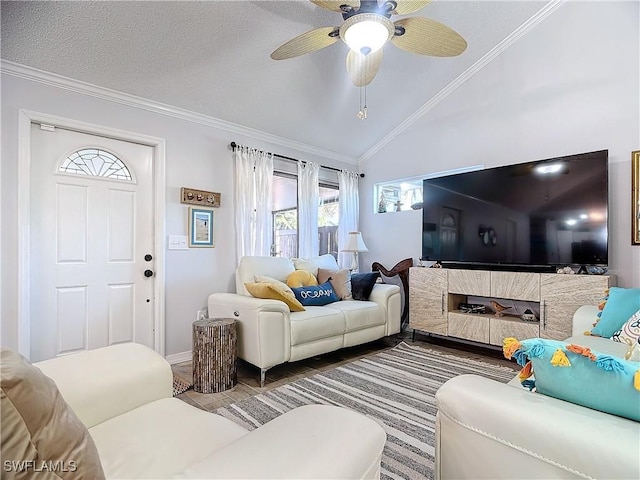 living room with a textured ceiling, vaulted ceiling, ceiling fan, and crown molding