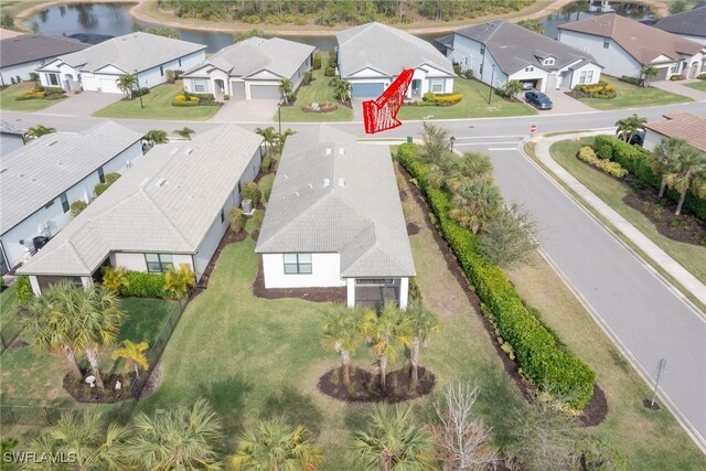 birds eye view of property with a water view