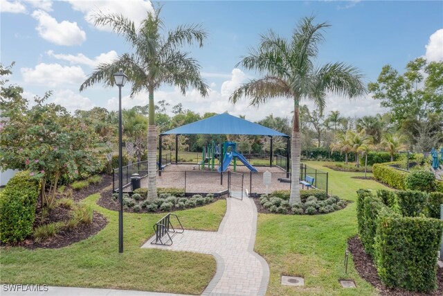 view of property's community with a yard and a playground