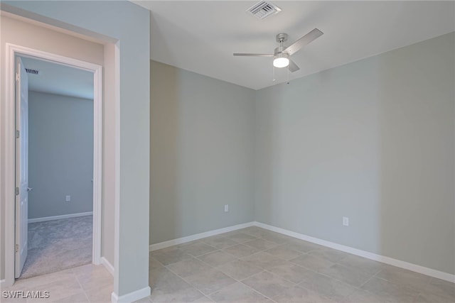 tiled empty room featuring ceiling fan